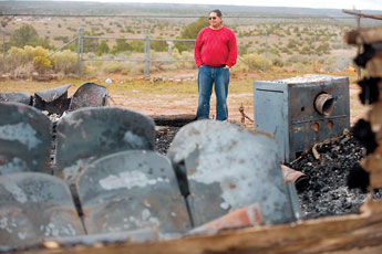 Gospel preacher Apache Crying Bear looks over the burnt remains of his church in Kinlichee Thursday. © 2011 Gallup Independent / Cable Hoover